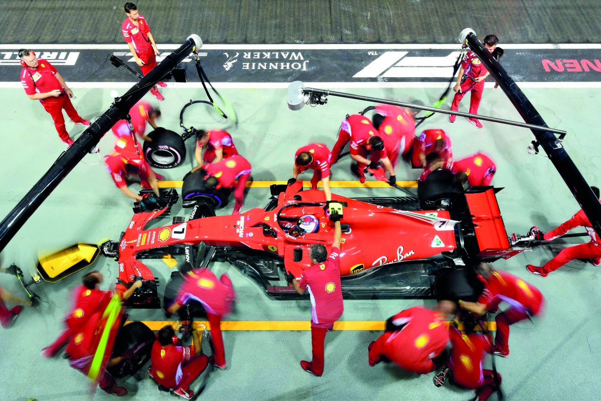 Ferrari's Finnish driver Kimi Raikkonen takes a pit stop during the second practice session at the Marina Bay Street Circuit ahead of the Singapore Formula One Grand Prix in Singapore on September 14, 2018. AFP / Manan Vatsyayana