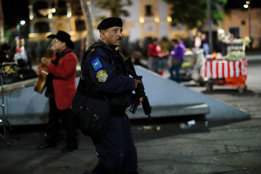 A policeman patrols the tourist Plaza Garibaldi after unknown assailants gunned down three men at an intersection on the edge of the plaza in Mexico City, Mexico September 14, 2018. REUTERS/Carlos Jasso