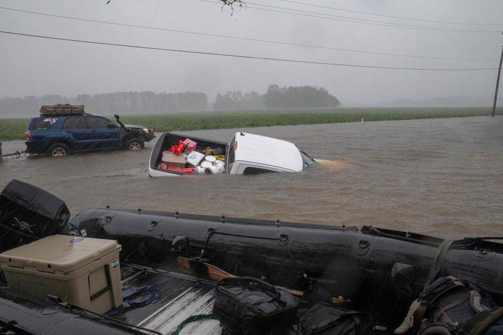 A pickup truck is seen submerged in floodwater in Lumberton, North Carolina, on September 15, 2018 in the wake of Hurricane Florence.  / AFP / Alex Edelman 