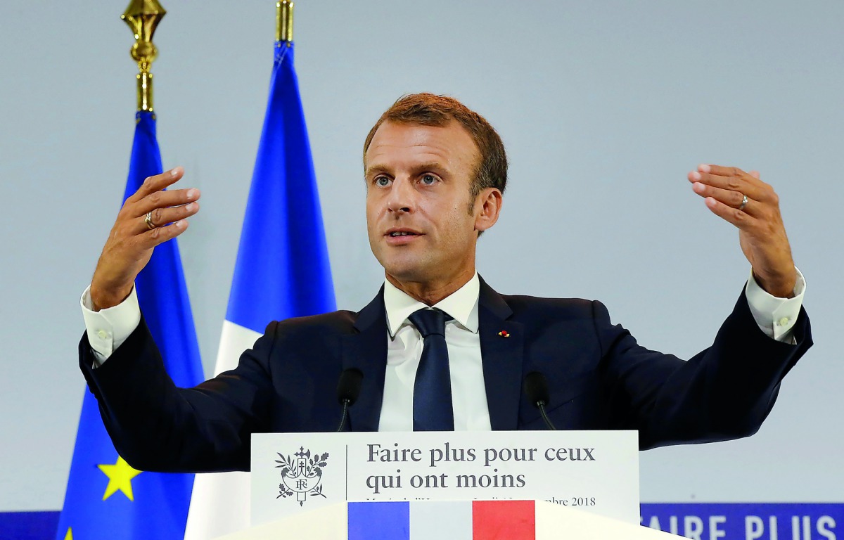French President Emmanuel Macron gestures as he delivers a speech on poverty to social aid workers in Paris, France, September 13, 2018. Picture taken September 13, 2018. Michel Euler/Pool via Reuters