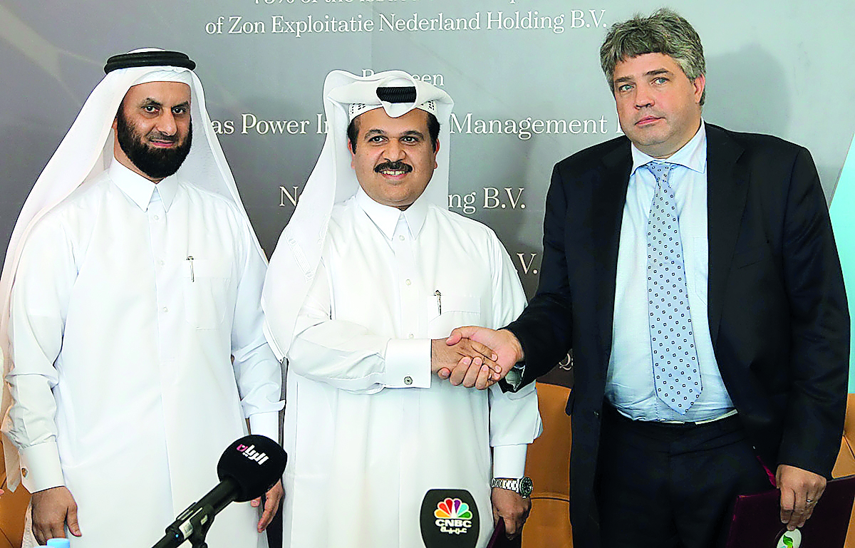 Khalid Mohammed Jolo (centre), CEO of Nebras; and Michel Peek (right), CEO of Zon Exploitatie Nederland Holding, shake hands as Faisal Al Siddiqi, Business Development Director of Nebras, looks on.