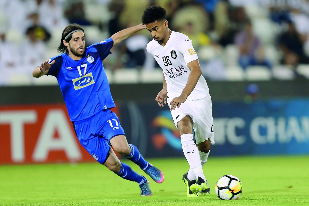 Al Sadd’s Akram Hassan (left) vies for the ball with Esteghlal’s Humam Tarek during their match  at the Jassim Bin Hamad Stadium in Doha yesterday. 