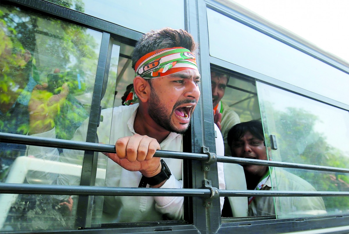 An activist of India’s main opposition Congress Party shouts slogans as he is detained by police during a protest, demanding total waiver of agricultural loans in Gandhinagar, India September 18, 2018. Reuters/Amit Dave