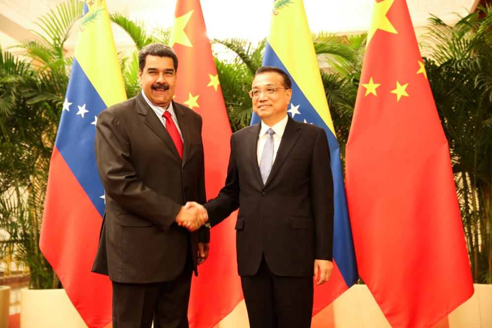 Venezuela's President Nicolas Maduro and Chinese Premier Li Keqiang shake hands during their meeting in Beijing, China September 14, 2018. Miraflores Palace/Handout via REUTERS 
