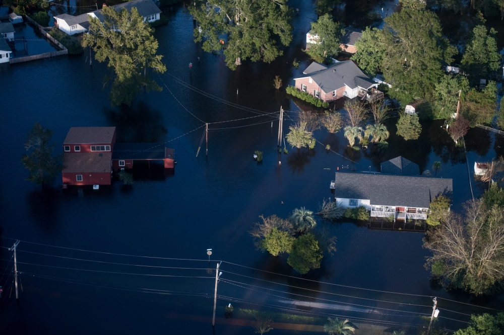 Homes are surrounded by floodwaters from Hurricane Florence on September 17, 2018 in Conway, South Carolina. Sean Rayford/Getty Images/AFP