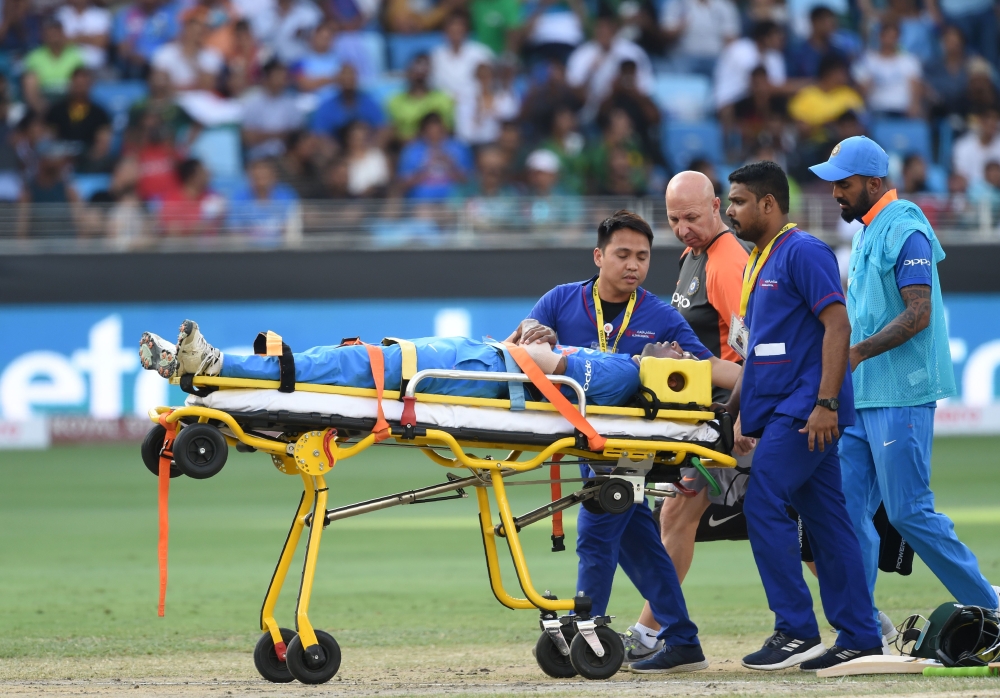 Indian cricketer Hardik Pandya is carried on a stretcher after getting injured during the one day international (ODI) Asia Cup cricket match between Pakistan and India at the Dubai International Cricket Stadium in Dubai on September 19, 2018. AFP / Ishara