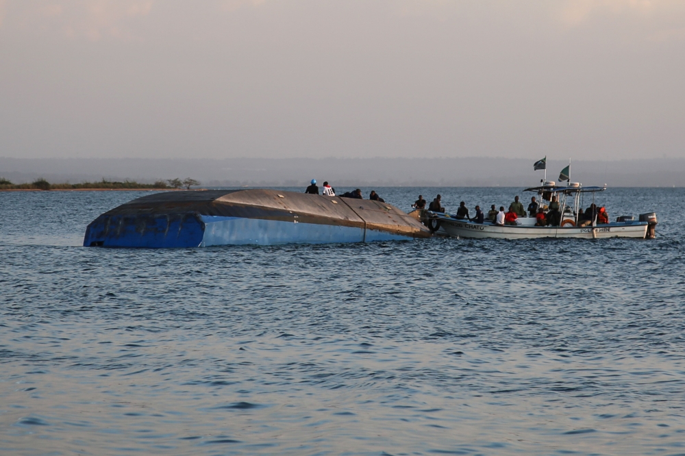 Investigators on boat work on the capsized ferry MV Nyerere which killed 131 people in Lake Victoria, Tanzania, on September 21, 2018.  AFP