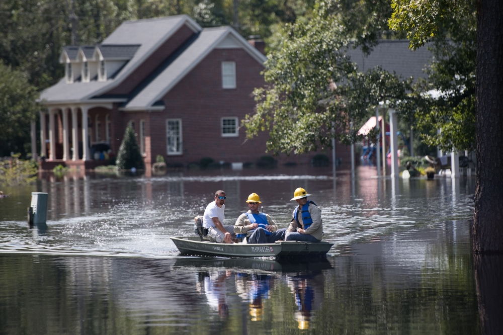 People navigate floodwaters caused by Hurricane Florence near the Waccamaw River on September 23, 2018 in Conway, South Carolina. Floodwaters are expected to continue to rise in Conway over the next two days. Sean Rayford/Getty Images/AFP