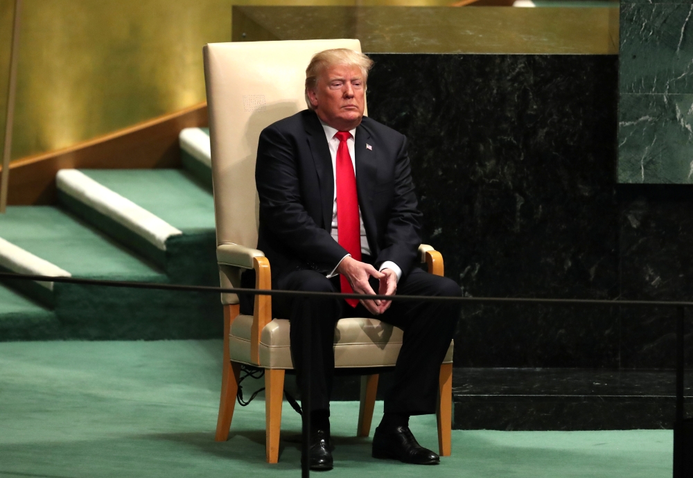 U.S. President Donald Trump sits in the chair reserved for heads of state before delivering his address during the 73rd session of the United Nations General Assembly at U.N. headquarters in New York, U.S., September 25, 2018. REUTERS/Carlo Allegri 