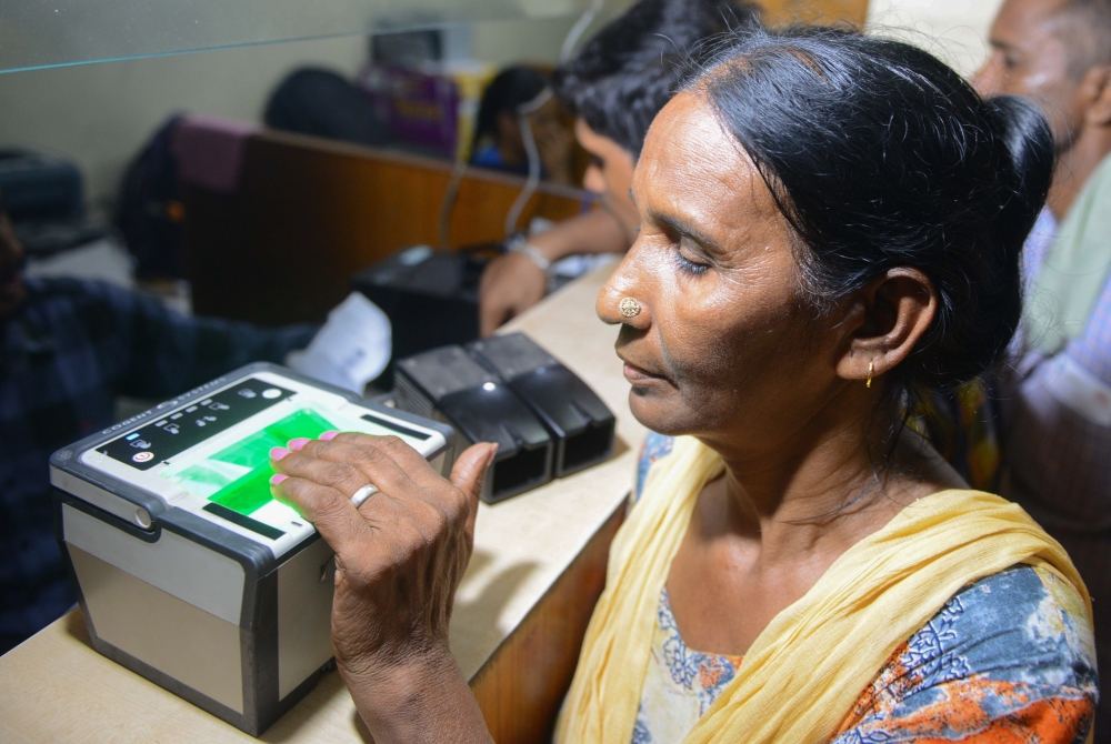 This photo taken on July 17, 2018 shows an Indian woman getting her fingerprints read during the registration process for Aadhaar cards (or unique identifier [UID] cards) in Amritsar. AFP / NARINDER NANU