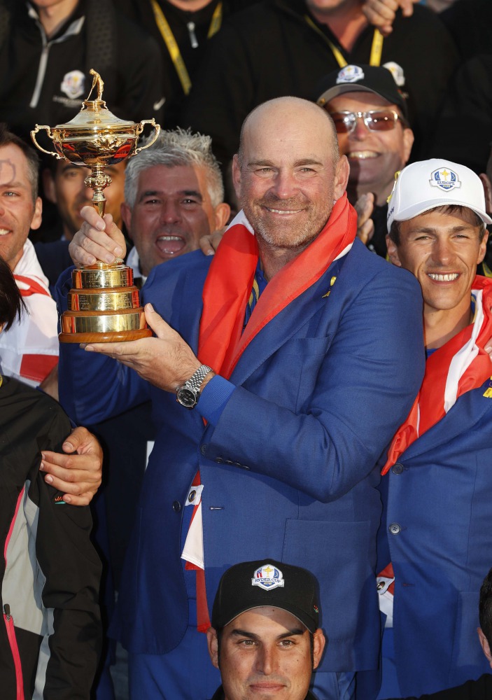 Team Europe players and captain Thomas Bjorn hold the trophy as they celebrate after winning the Ryder Cup. Reuters/Paul Childs

