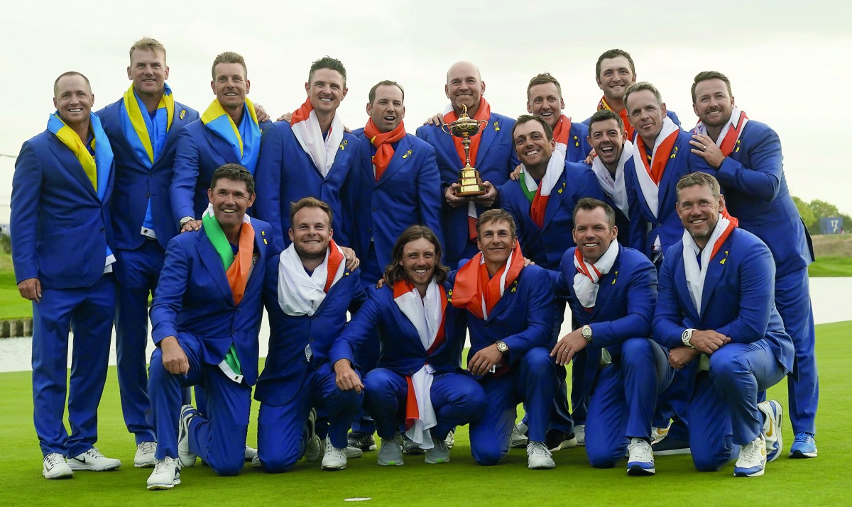 Team Europe players and captain Thomas Bjorn hold the trophy as they celebrate after winning the Ryder Cup.Reuters/Paul Childs 