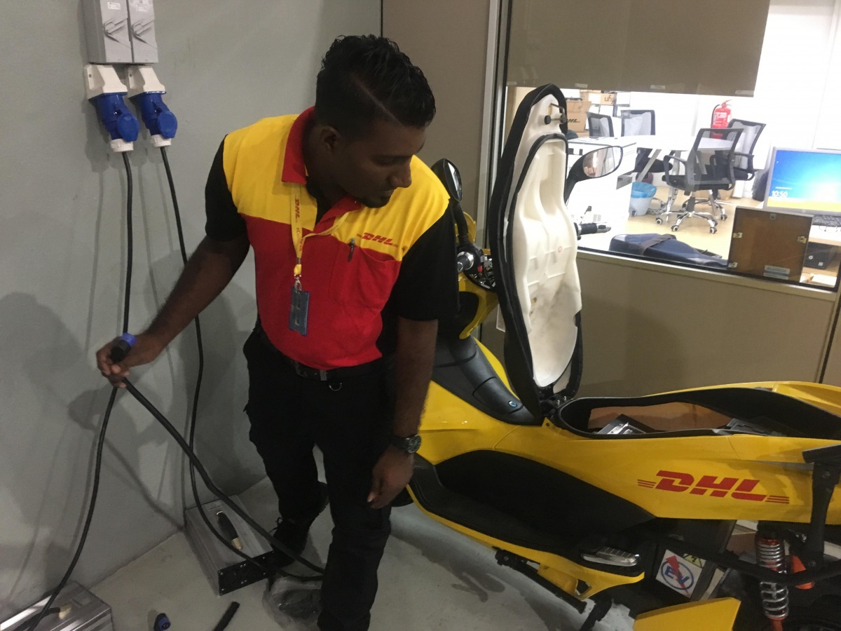 Benjamin Jacob, a delivery driver for DHL eCommerce, tests his electric scooter at a depot on the outskirts of Kuala Lumpur, Malaysia, September 20, 2018. Thomson Reuters Foundation/Michael Taylor