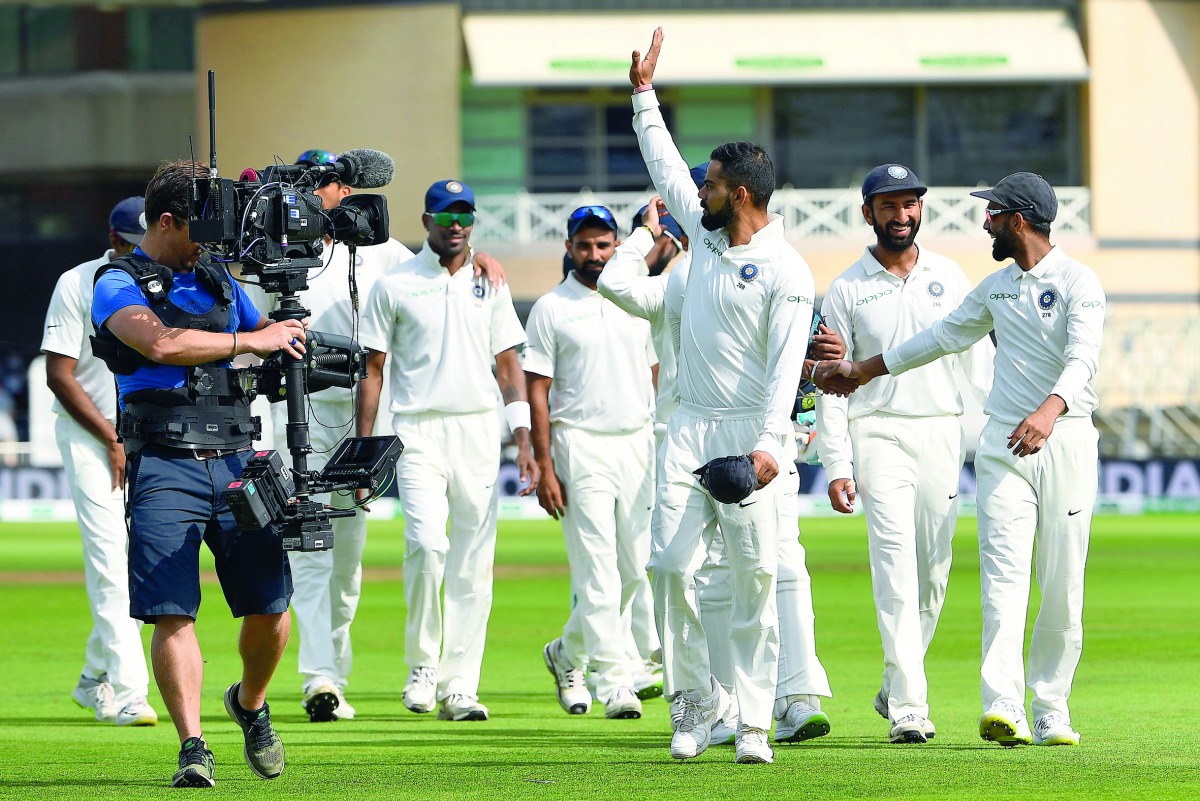 India’s captain Virat Kohli (centre) waves to fans after winning the third Test against Englandin Nottingham,  in this August 22, 2018 file photo.