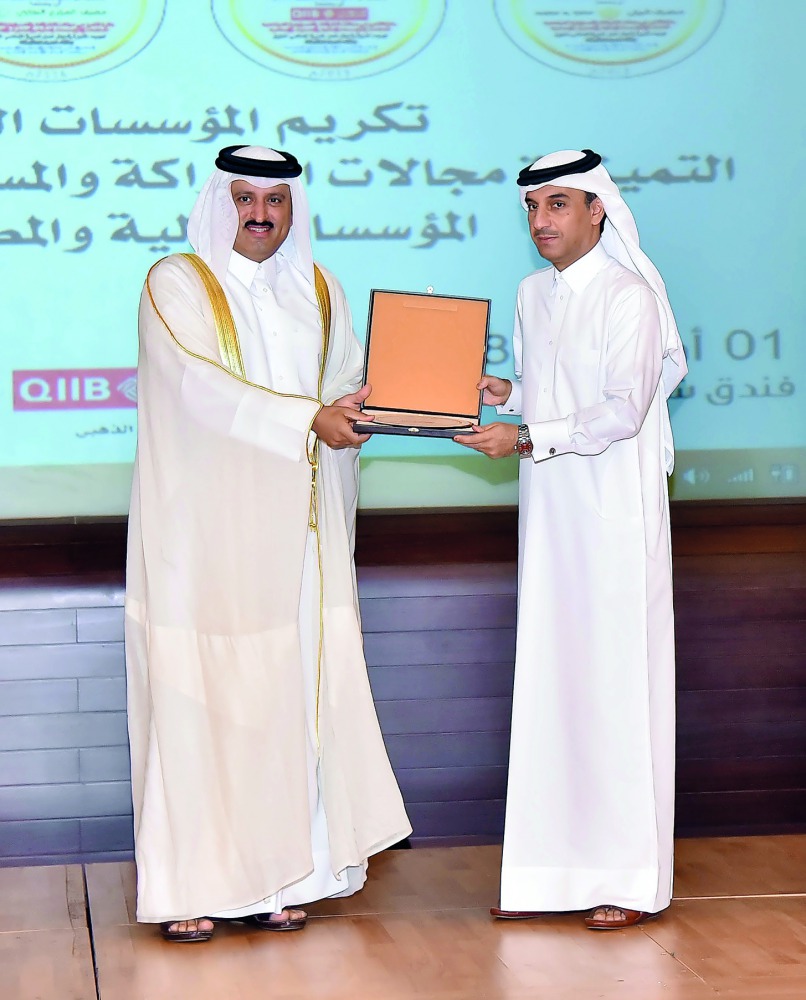Jamal Abdullah Al Jamal (right), QIIB Deputy CEO, receiving the Banking Excellence for Partnership and Corporate Social Responsibility (CSR) Award, 2018, on behalf of the bank.