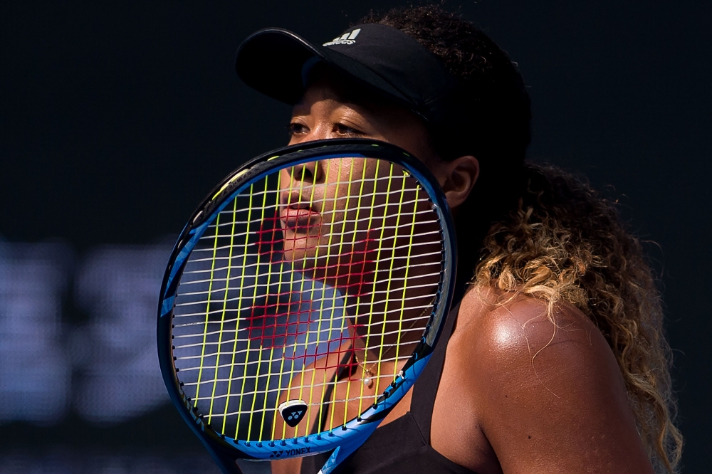 Naomi Osaka of Japan waits during her women's singles quarter finals match against Zhang Shuai of China at the China Open tennis tournament in Beijing on October 5, 2018. / AFP / NICOLAS ASFOURI
