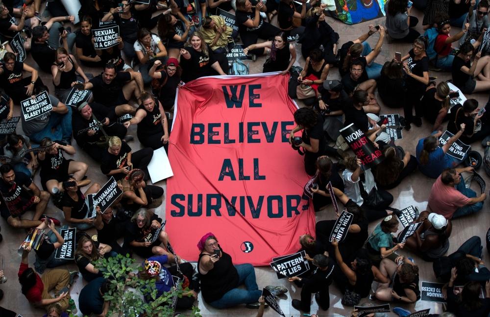 Protesters unfurl a sign as they occupy the Senate Hart building during a rally against Supreme Court nominee Brett Kavanaugh on Capitol Hill in Washington, DC on October 4, 2018.  AFP / Andrew Caballero-Reynolds 