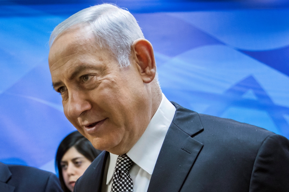 TV screen shows Israeli Prime Minister Benjamin Netanyahu delivering a speech after the US President announced his decision to withdraw from the Iranian nuclear deal on May 8, 2018. AFP/Thomas Coex