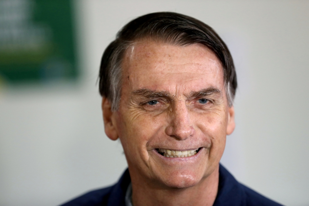 FILE PHOTO: Jair Bolsonaro, far-right lawmaker and presidential candidate of the Social Liberal Party (PSL), casts his vote in Rio de Janeiro, Brazil October 7, 2018. REUTERS/Ricardo Moraes/

