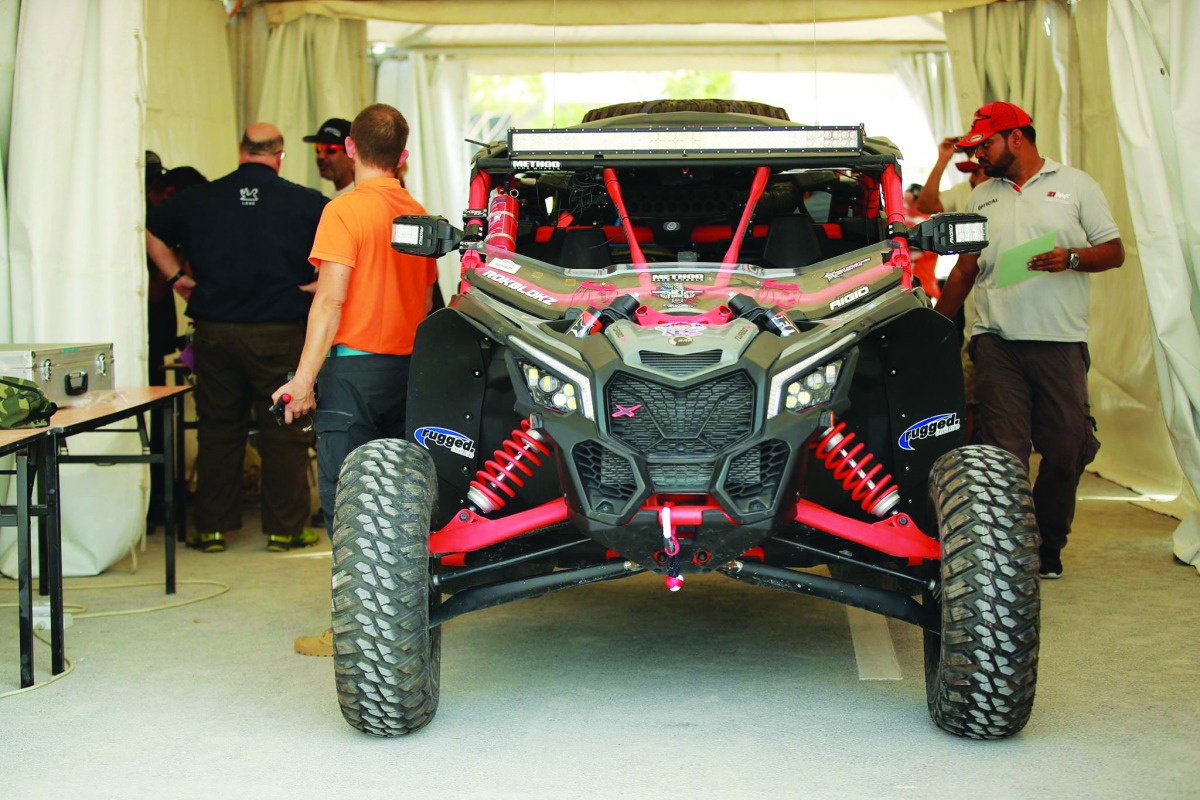 Drivers and mechanics are seen during the scrutineering process at the QMMF headquarters yesterday, on the eve of the third round of the Qatar Manateq Baja which will be held today. The ceremonial start will be held at 8.00am with the official start sched