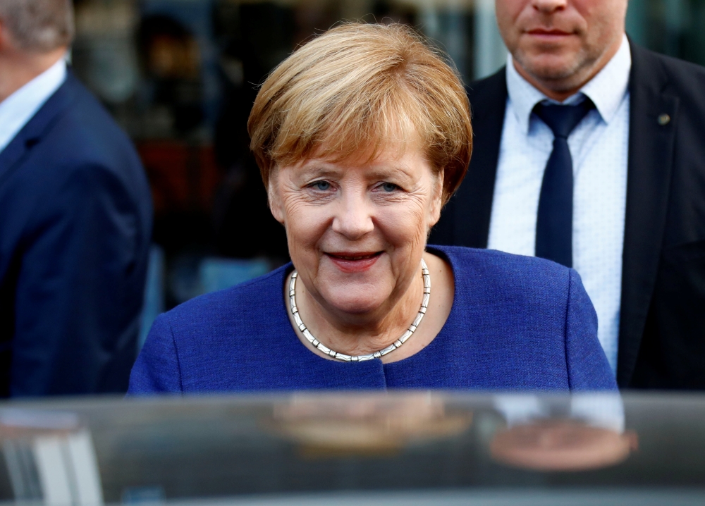 German Chancellor Angela Merkel leaves an event of the Federation of German Wholesalers and Retailers (BGA) in Berlin, Germany, October 15, 2018. REUTERS/Fabrizio Bensch