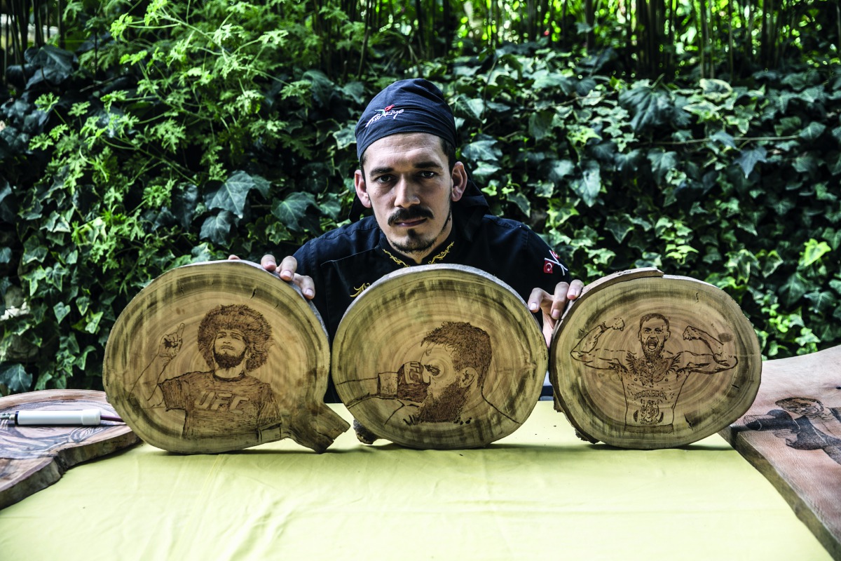 Portraits of Conor McGregor and Khabib Nurmagomedov burned on wood by cook Halil Bozkurt are seen in Turkey's Hatay, on October 13, 2018. Bozkurt, uses wood burning technique to create various people's portraits. (Cem Genco/Anadolu Agency)
