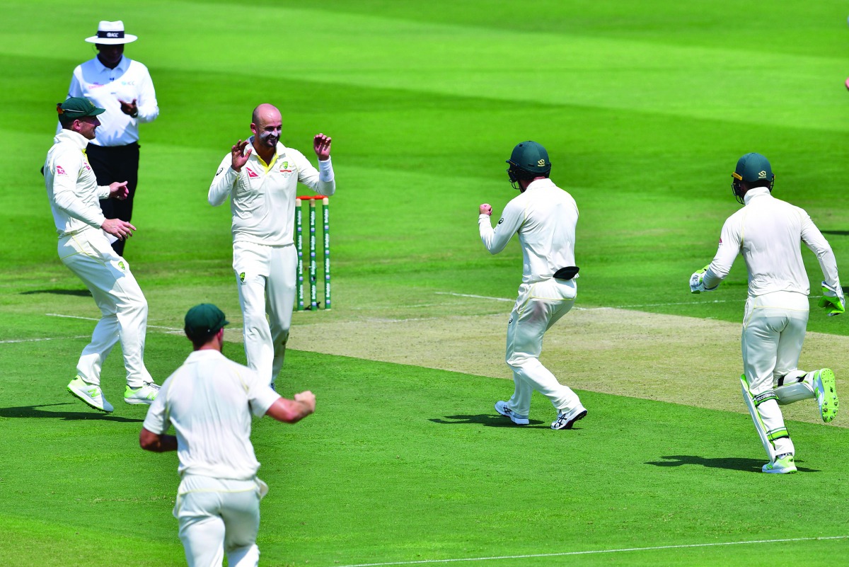 Australia cricketer Nathan Lyon (2nd L) celebrates after he dismissed Pakistan cricketer Asad Shafiq during day one of the second Test cricket match in the series between Australia and Pakistan at the Abu Dhabi Cricket Stadium in Abu Dhabi on October 16, 