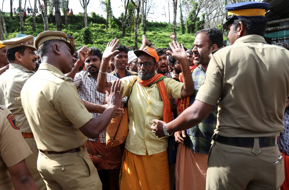 Policemen control the members of the Hindu groups at the Nilakkal Base Camp, to prevent them from clashing with women of menstrual age entering Sabarimala temple for the first time in centuries, in Pathanamthitta, in the southern state of Kerala, India, O