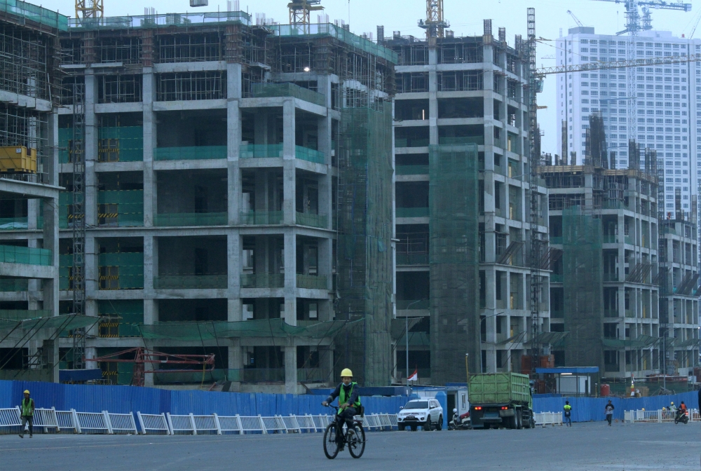 A worker rides a bicycle in the Meikarta development in Cikarang, Bekasi, east of Jakarta, Indonesia, October 15, 2018 in this photo taken by Antara Foto. Picture taken October 15, 2018. Antara Foto/Risky Andrianto/ via REUTERS 