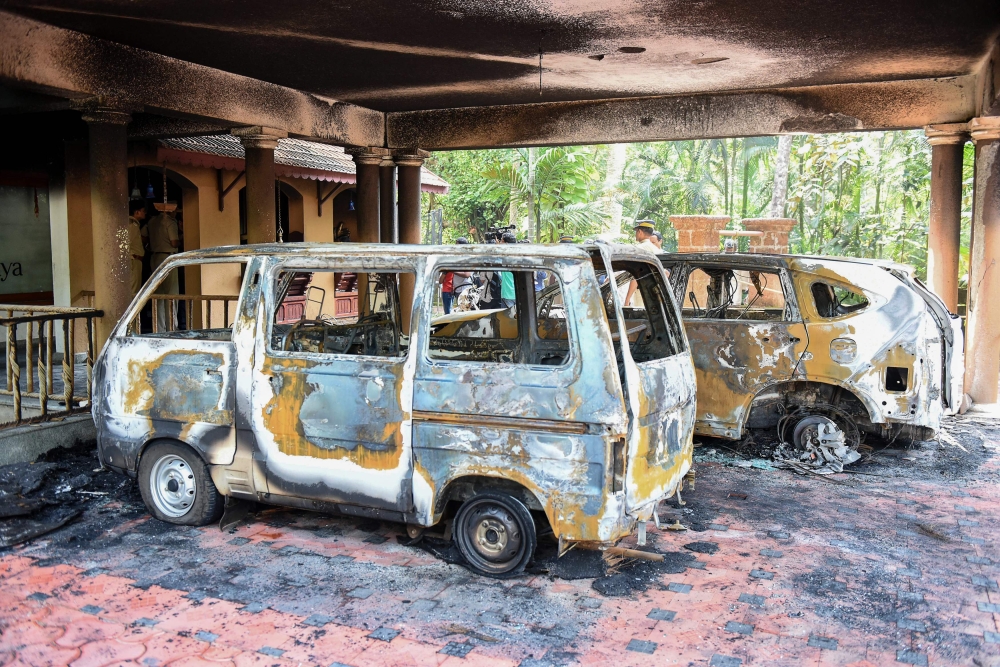 Charred vehicles are pictured at a spiritual retreat after it was set ablaze in Kundamankadavu on the outskirts of Thiruvananthapuram in southern Kerala state on October 27, 2018. AFP 
