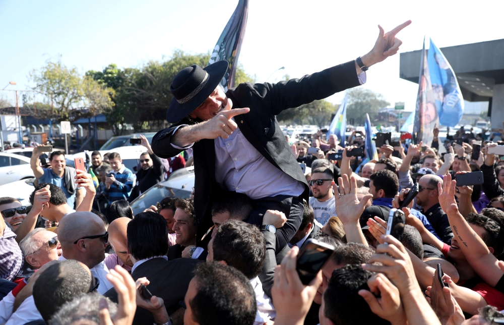 FILE PHOTO: Presidential candidate Jair Bolsonaro arrives at the Salgado Filho airport to attend a rally in Porto Alegre, Brazil August 29, 2018. REUTERS/Diego Vara/File photo