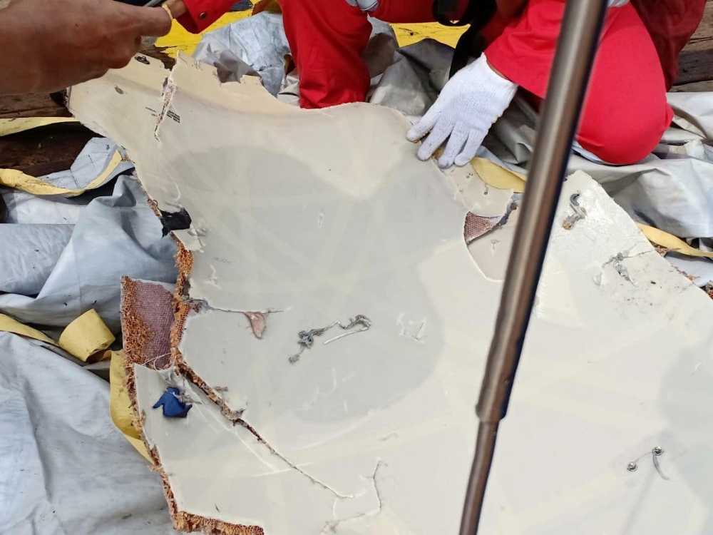 Workers of PT Pertamina examine recovered debris of what is believed from the crashed Lion Air flight JT610, onboard Prabu ship owned by PT Pertamina, off the shore of Karawang regency, West Java province, Indonesia, October 29, 2018. Antara Foto/PT Perta