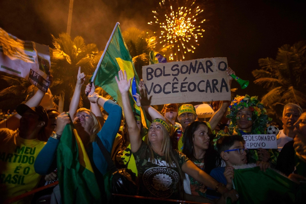  Supporters of far-right presidential candidate Jair Bolsonaro, celebrate in front of his house in Rio de Janeiro, Brazil, after he won Brazil's presidential election, on October 28, 2018. AFP / Mauro Pimentel