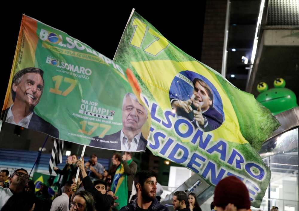 Supporters of Jair Bolsonaro, far-right lawmaker and presidential candidate of the Social Liberal Party (PSL), react after Bolsonaro wins the presidential race, in Sao Paulo, Brazil October 28, 2018. REUTERS/Nacho Doce