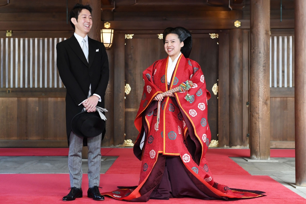 This picture taken on October 29, 2018 shows Japanese Princess Ayako (R) and her husband Kei Moriya answering questions from journalists after their wedding ceremony at the Meiji Shrine in Tokyo. Japan OUT / AFP / JAPAN POOL / JIJI PRESS 