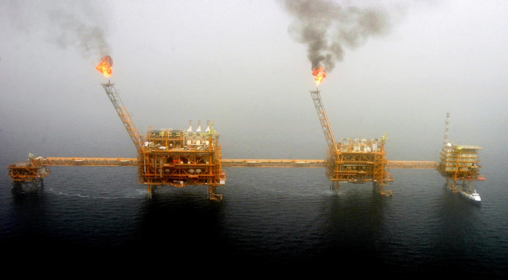 Gas flares from an oil production platform at the Soroush oil fields, south of the capital Tehran, July 25, 2005. (REUTERS/Raheb Homavandi/File Photo)