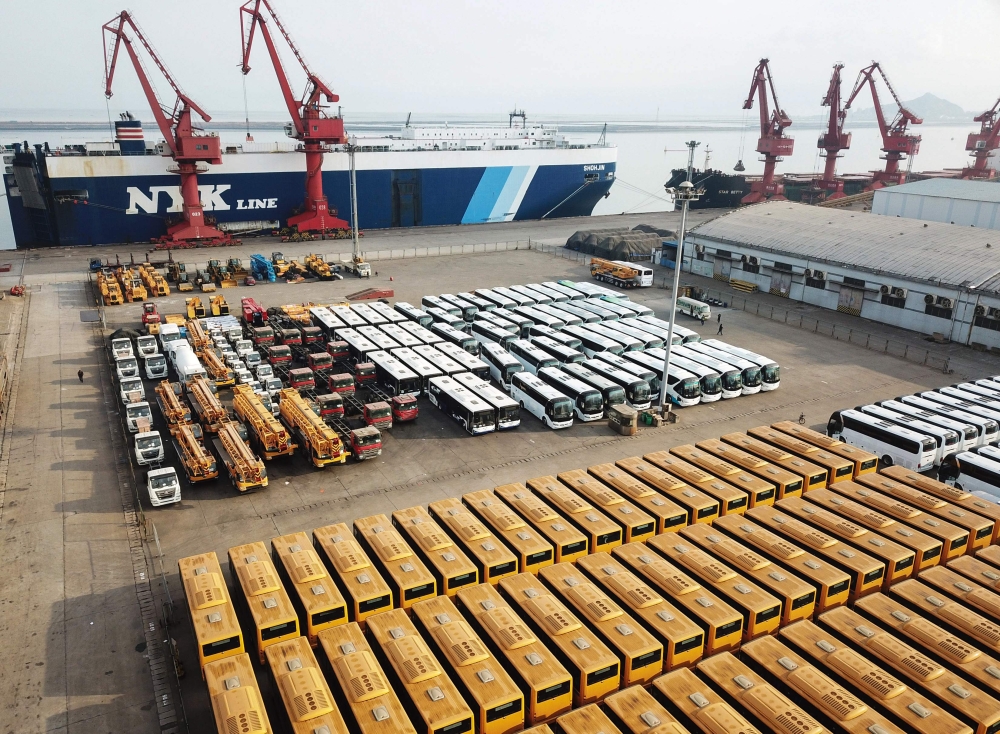 This photo taken on November 4, 2018 shows new buses lined up for export at a port in Lianyungang, east China's Jiangsu province. China OUT / AFP / STR