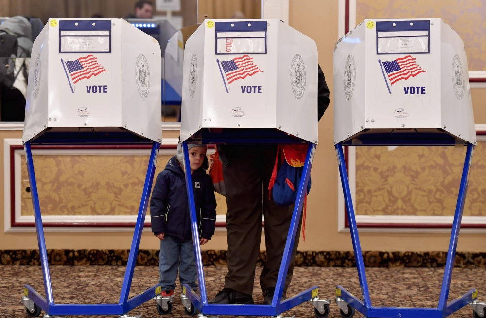 A voter casts his ballot in the midterm election at the East Midwood Jewish Center polling station in the Brooklyn borough of New York City on November 6, 2018. Americans started voting Tuesday in critical midterm elections that mark the first major voter