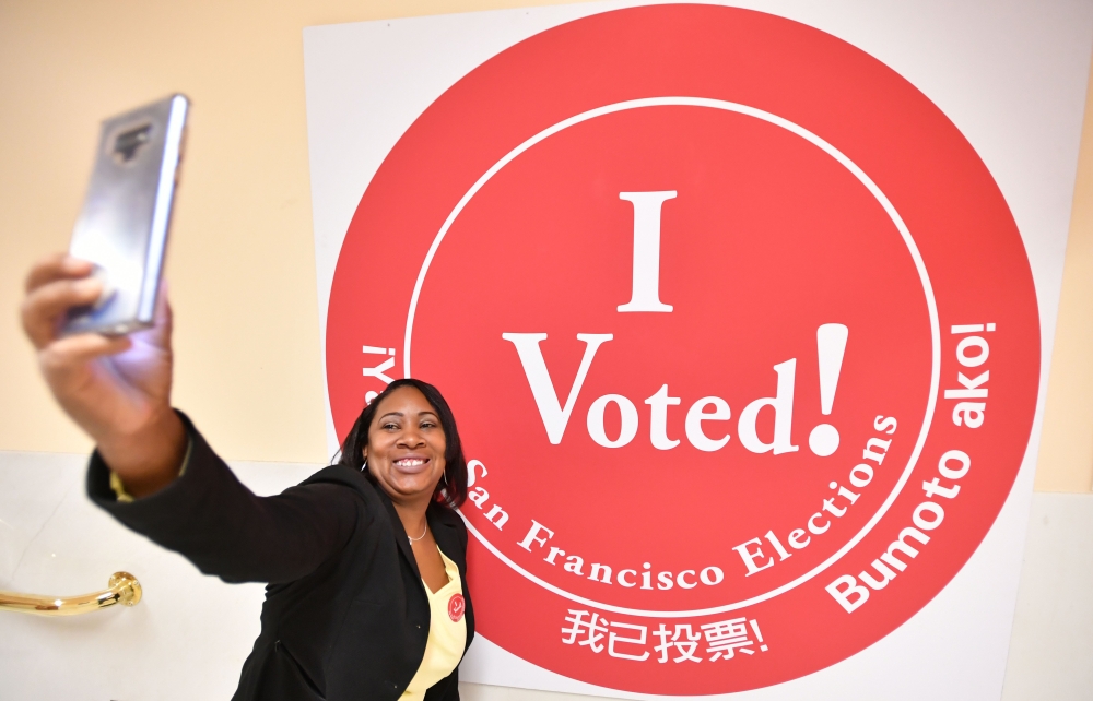 A woman takes a selfie after voting at City Hall in San Francisco on November 6, 2018. AFP/Josh Edelson