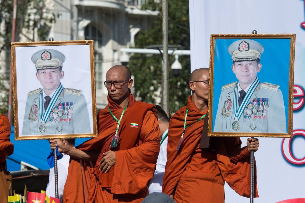 Monks hold portraits of Myanmar military commander-in-chief Senior General Min Aung Hlaing during a rally to show support to the Myanmar military in Yangon on October 14, 2018. (AFP/Ye Aung Thu) 