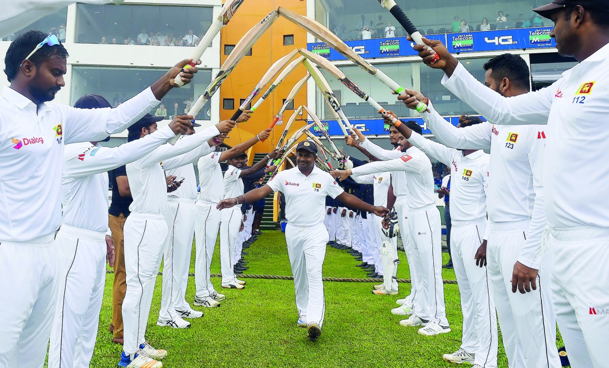 Sri Lanka's Rangana Herath (C) gestures as he arrives for the first day of the opening Test cricket match between Sri Lanka and England at the Galle International Cricket Stadium in Galle on November 6, 2018. / AFP / Ishara S Kodikara

