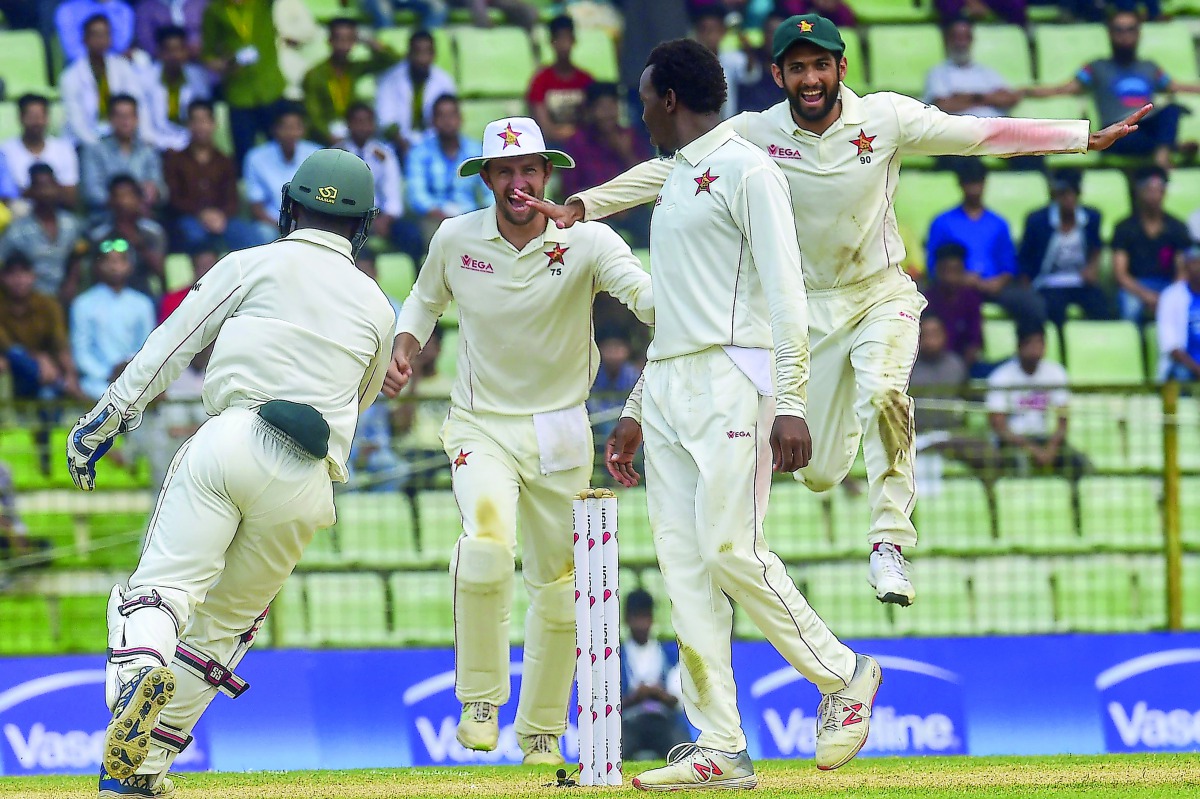 Zimbabwe cricketers celebrate after winning the match on the fourth day of the first Test cricket match between Bangladesh and Zimbabwe in Sylhet on November 6, 2018. AFP / Munir Uz Zaman
