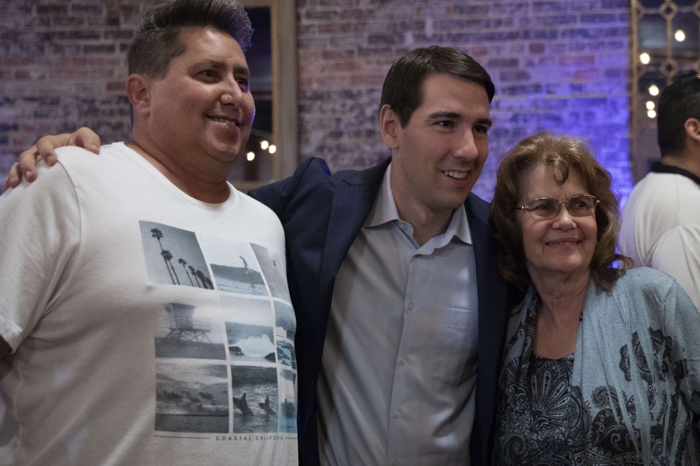Democratic candidate for California's 10th Congressional District Josh Harder poses for a photo with supporters at an election night event on November 6, 2018 in Modesto, California. Alex Edelman/Getty Images/AFP 