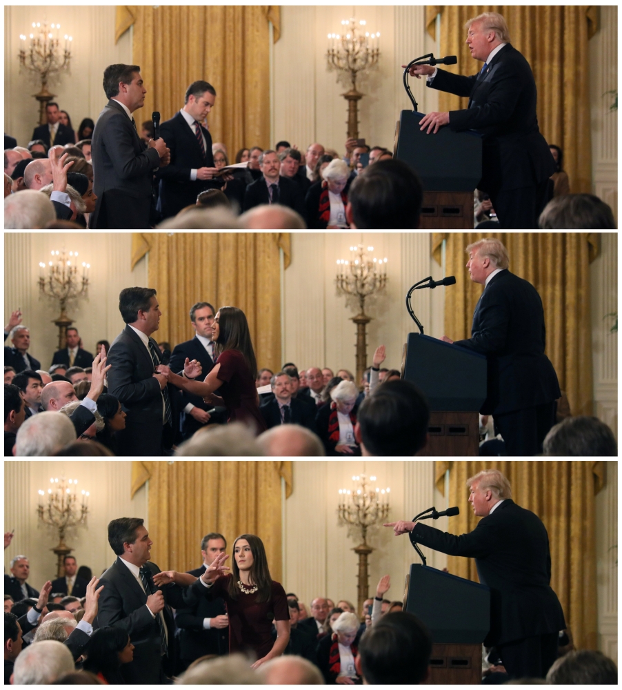 A White House staff member reaches for the microphone held by CNN's Jim Acosta as he questions U.S. President Donald Trump during a news conference following November 7, 2018. Reuters/Jonathan Ernst
 