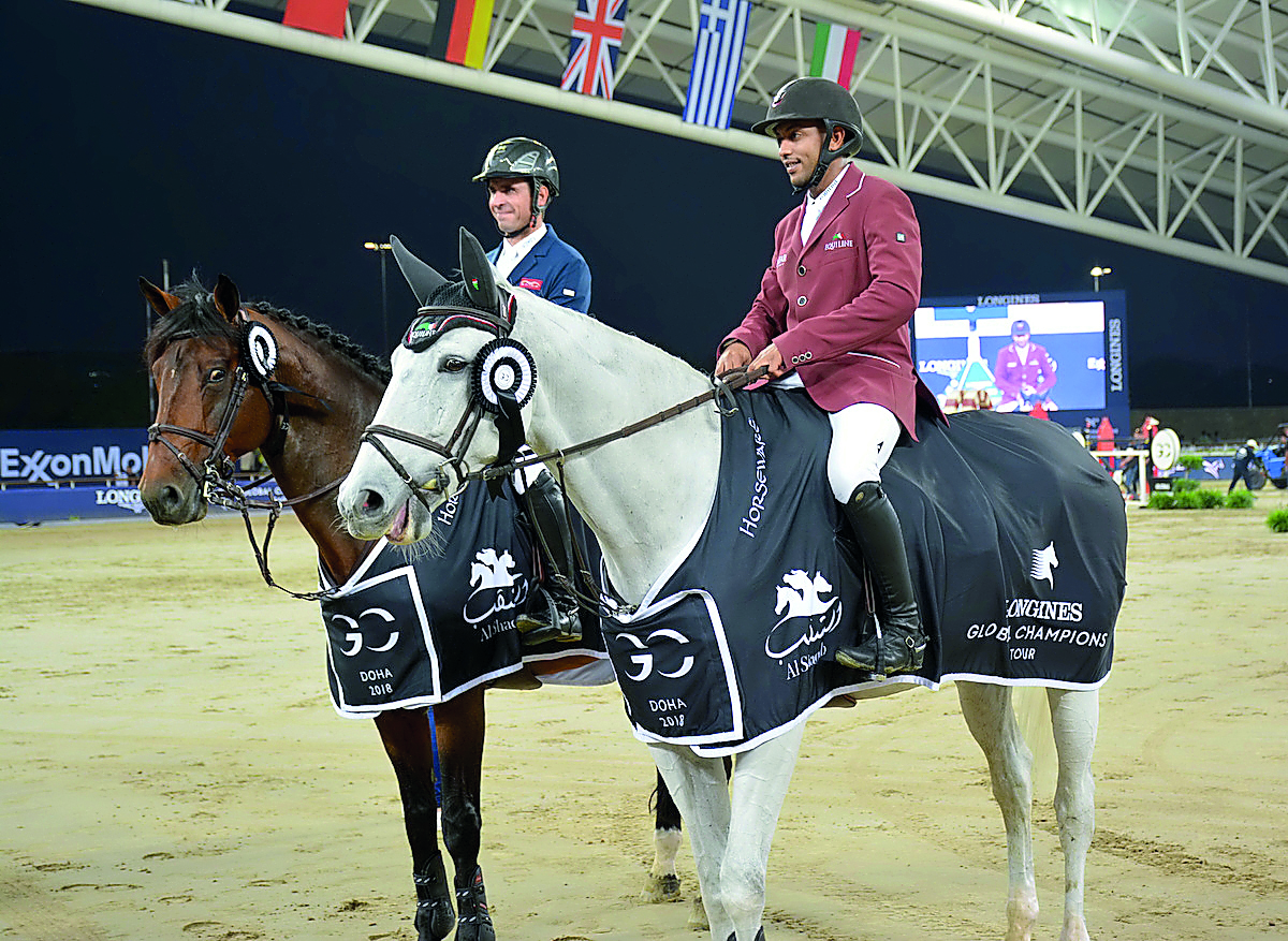 Qatar’s Bassem Hassan Mohammed (right) and France’s Julien Epaillard pose for photographs after the opening event of the LGCT final round at Al Shaqab Arena in Doha yesterday.