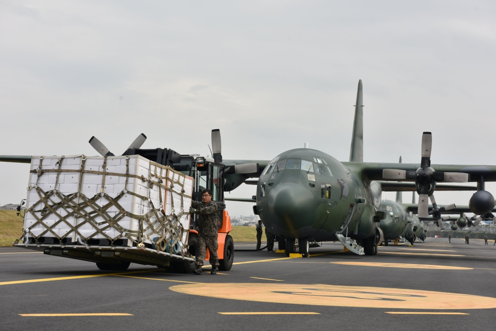 Boxes of tangerines are loaded into South Korean Air Force's cargo plane at the Jeju International Airport in Jeju Island, South Korea November 11, 2018. Yonhap via REUTERS 