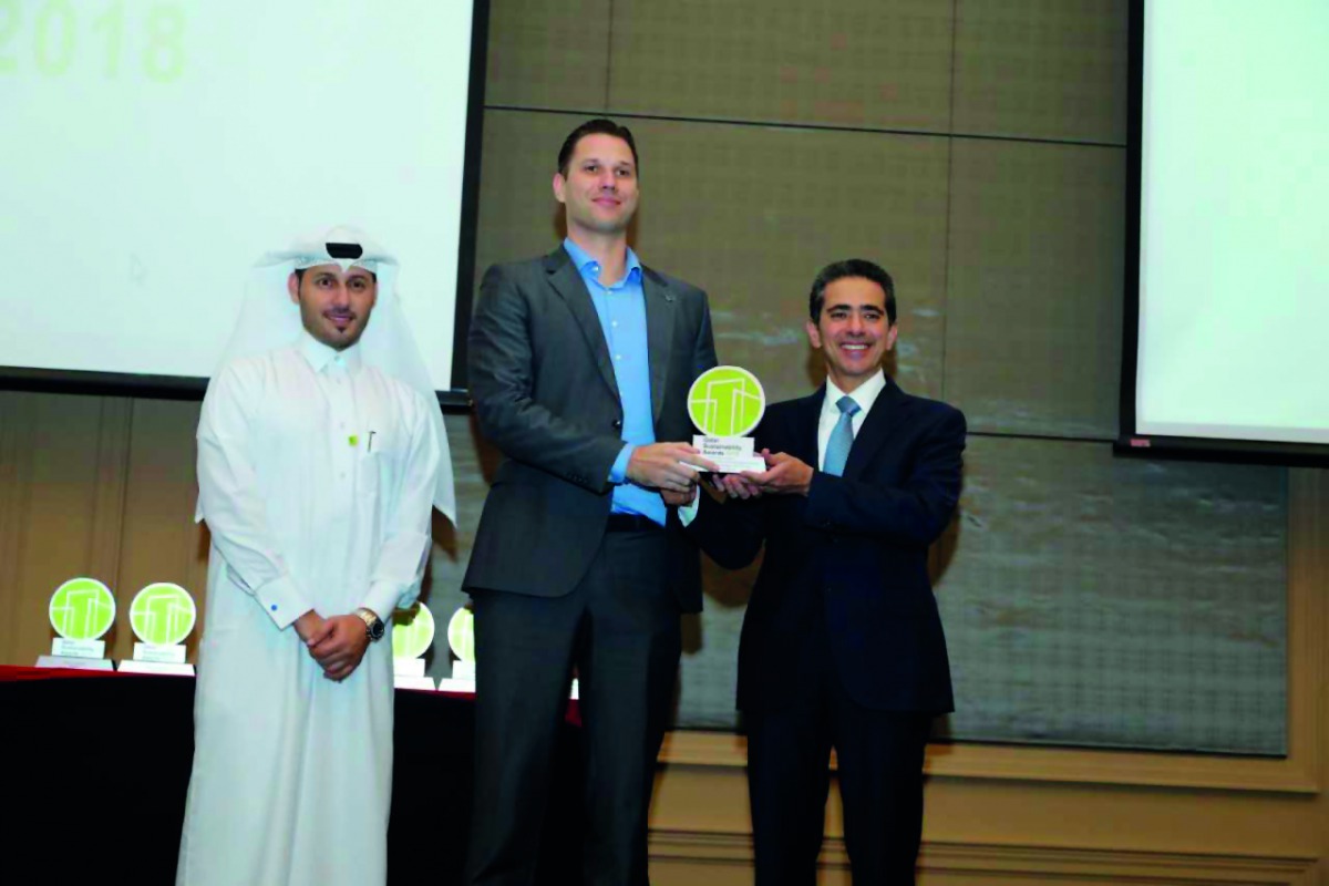A Qatar sustainability award winner with the officials.
