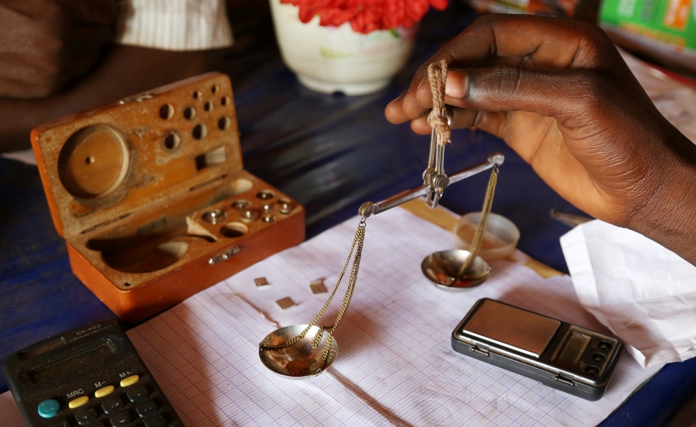 FILE PHOTO: A trader weighs gold in his shop in Djoubissi, Central African Republic on April 24, 2014. Reuters/Emmanuel Braun