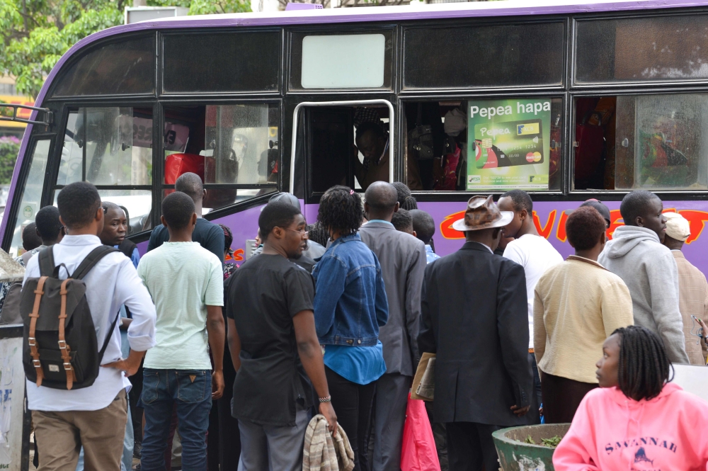 Commuters board a bus as police kicked off a major crackdown targeting non-compliant Public Service Vehicles (PSV) operators country wide, in Nairobi, on November 12, 2018. AFP / Simon Maina 