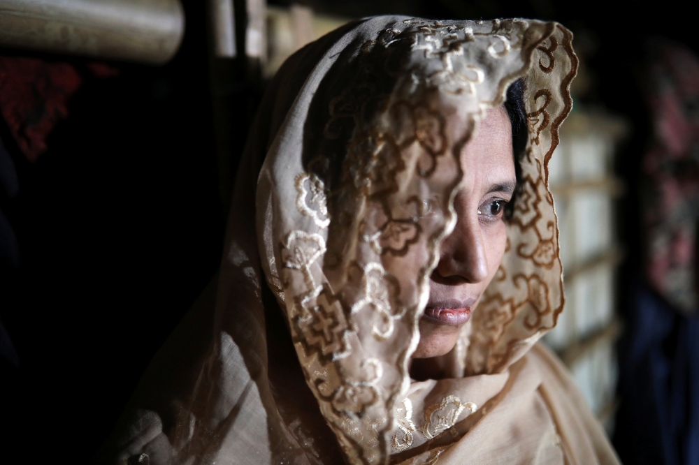 Taiyeba Begum (35), a Rohingya refugee woman who takes shelter in her relatives' house with other family members to avoid forced repatriation, looks on at a camp in Cox's Bazar, Bangladesh, November 14, 2018. Reuters/Mohammad Ponir Hossain